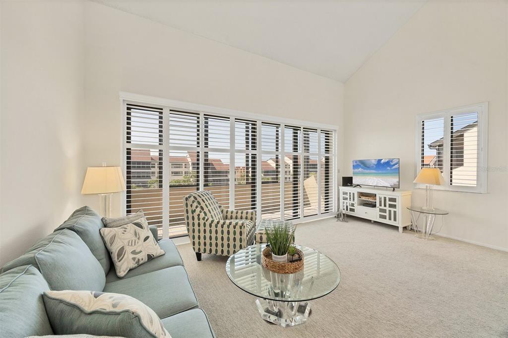 6285 Midnight Pass Road, Unit 403 Sarasota, FL 34242 - Photo 6 of 53 a living room with furniture and a table