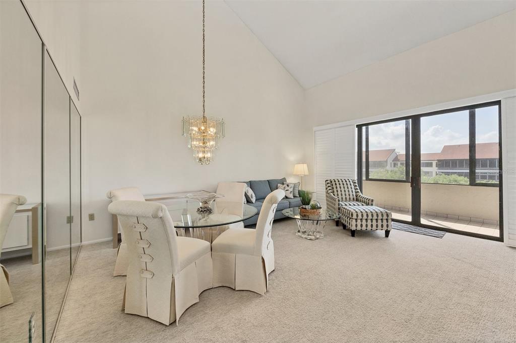 6285 Midnight Pass Road, Unit 403 Sarasota, FL 34242 - Photo 8 of 53 a living room with furniture and a chandelier