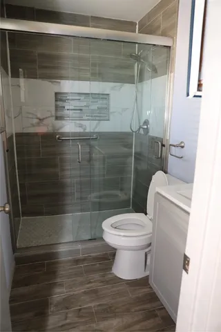 a bathroom with a toilet and a shower