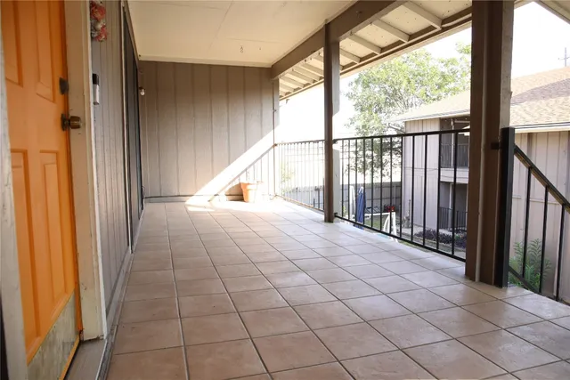 a view of a balcony with wooden floor