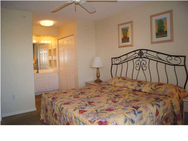 970 Highway 98, Unit 202 Destin, FL 32541 - Photo 11 of 26 a bedroom with a bed and a window