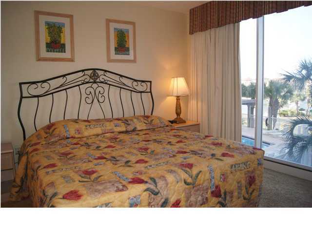 970 Highway 98, Unit 202 Destin, FL 32541 - Photo 12 of 26 a bedroom with a bed mirror and a window