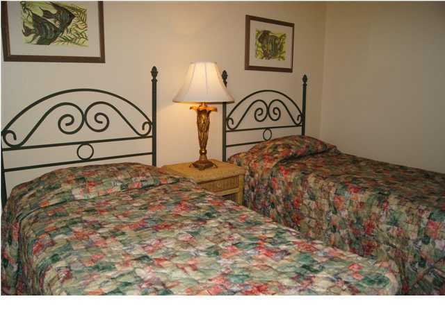 970 Highway 98, Unit 202 Destin, FL 32541 - Photo 16 of 26 a bedroom with a bed and a painting on the wall