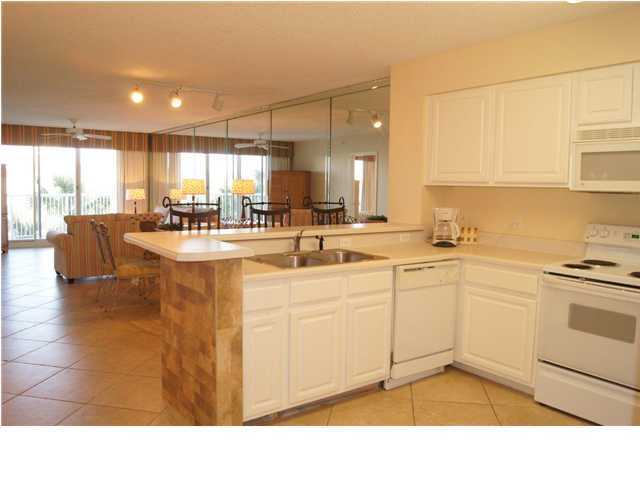 970 Highway 98, Unit 202 Destin, FL 32541 - Photo 19 of 26 a kitchen with sink refrigerator and cabinets