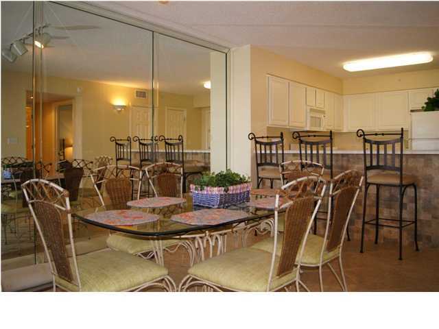 970 Highway 98, Unit 202 Destin, FL 32541 - Photo 6 of 26 a dining room with furniture a chandelier and wooden floor