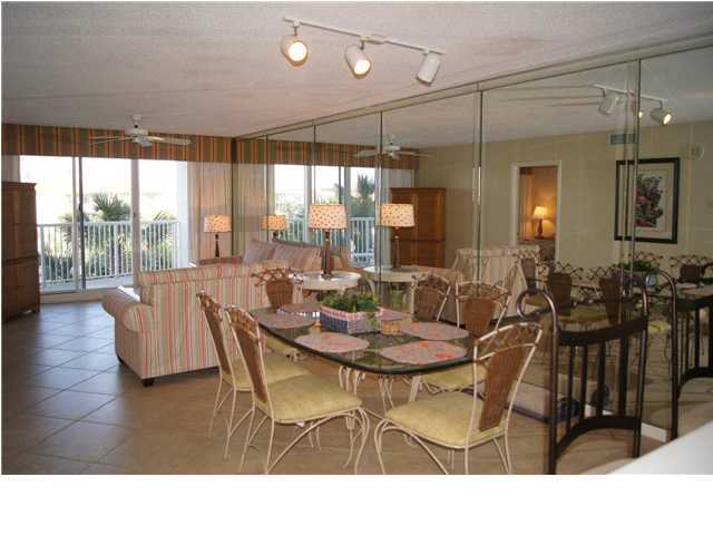 970 Highway 98, Unit 202 Destin, FL 32541 - Photo 7 of 26 a dining room with furniture a chandelier and wooden floor