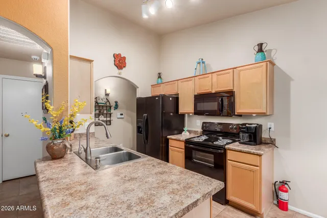 a kitchen with a refrigerator and a stove top oven
