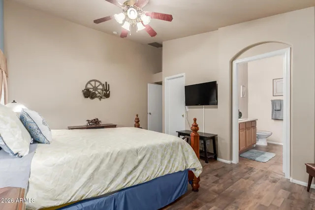 a bedroom with a bed and a flat screen tv