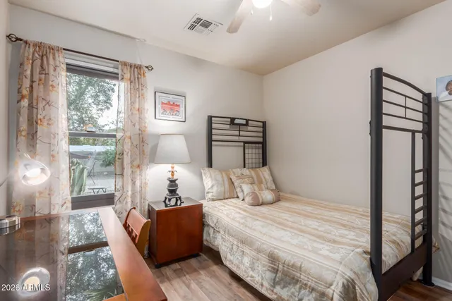 a bedroom with a bed and wooden floor