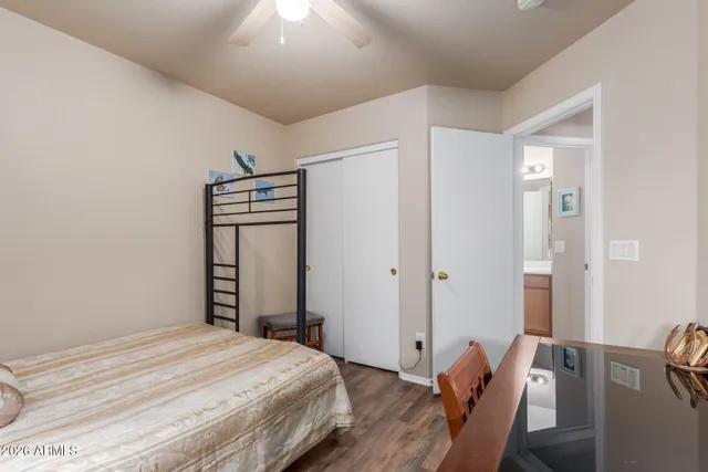 a bedroom with a bed and a mirror