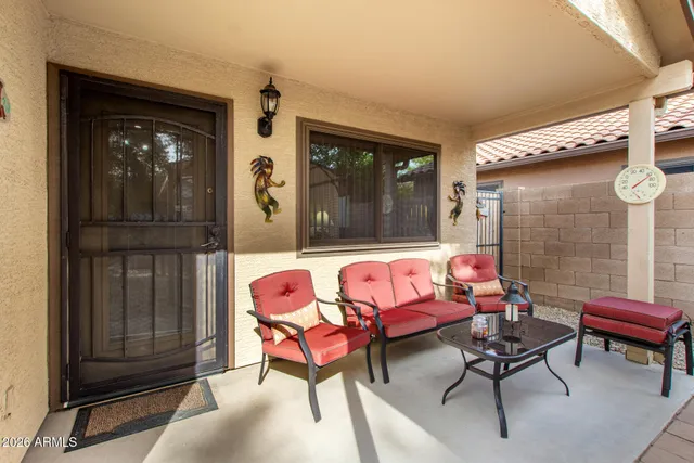 a backyard of a house with outdoor seating