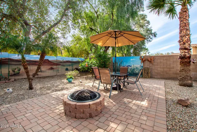 a view of a house with a tree in front of it