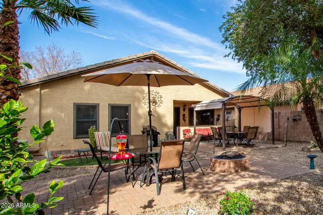a view of backyard with outdoor seating and trees