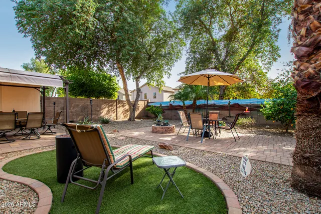 a view of a tennis ground with large trees