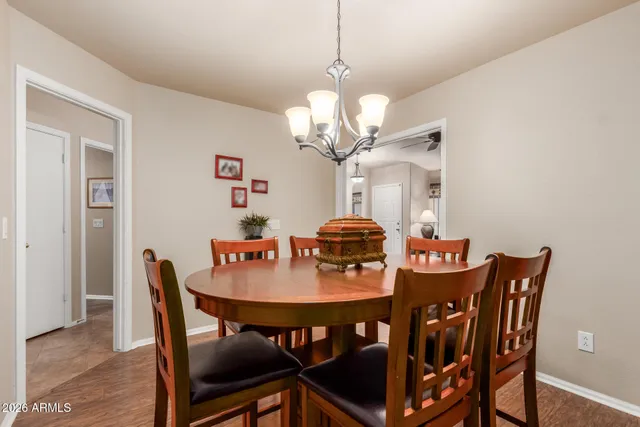 a view of a dining room with furniture and chandelier
