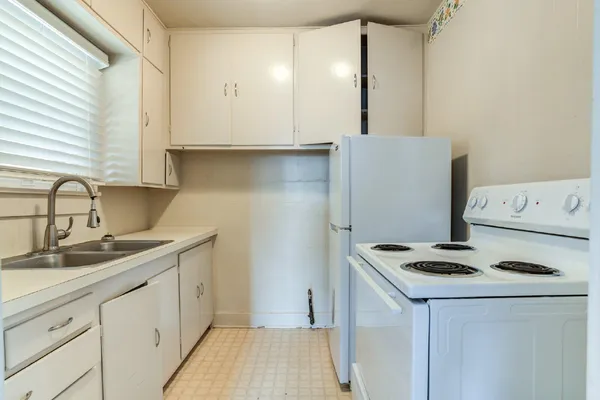 a kitchen with sink cabinets and stove