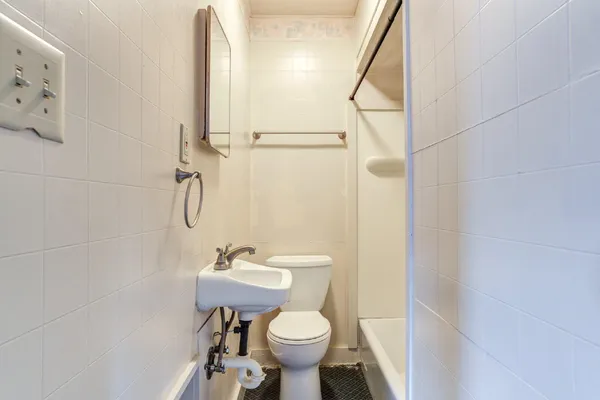 a bathroom with a sink toilet and a mirror