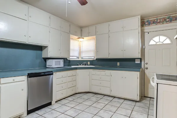 a kitchen with white cabinets