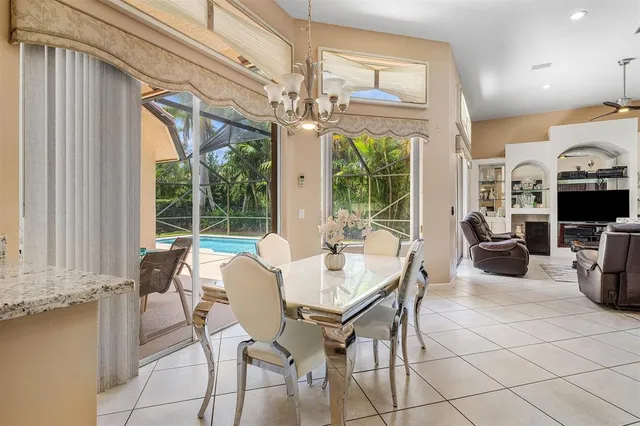 a view of a dining room with furniture large windows and wooden floor