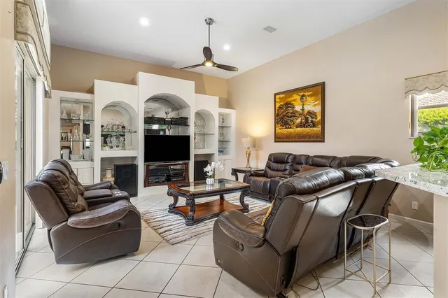 a living room with furniture fireplace and a large window