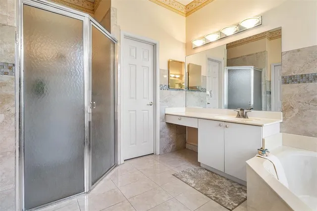 a bathroom with a double vanity sink mirror and shower
