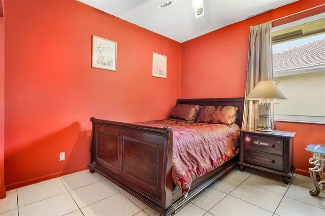 a bedroom with a bed and a lamp with window