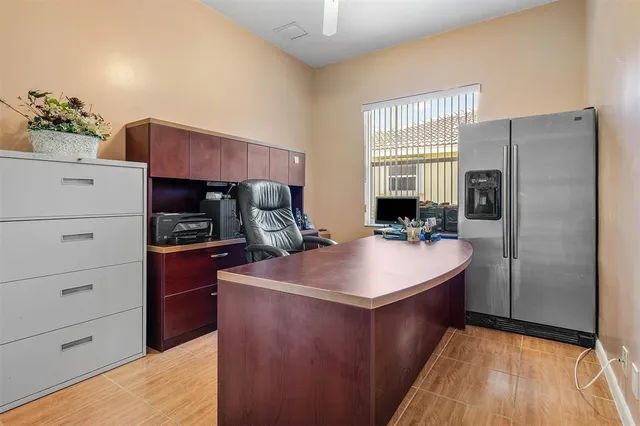a kitchen with a refrigerator and a stove top oven