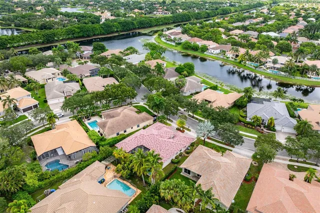 an aerial view of residential houses with outdoor space and lake view