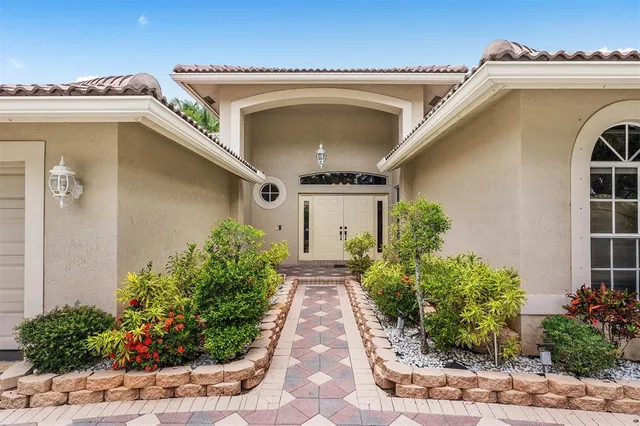 a front view of a house with plants