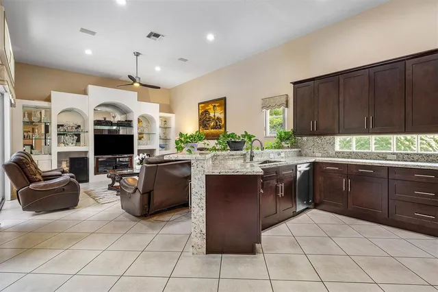 a kitchen with a sink cabinets and window