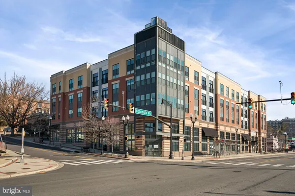 a city street lined with tall buildings and a street light