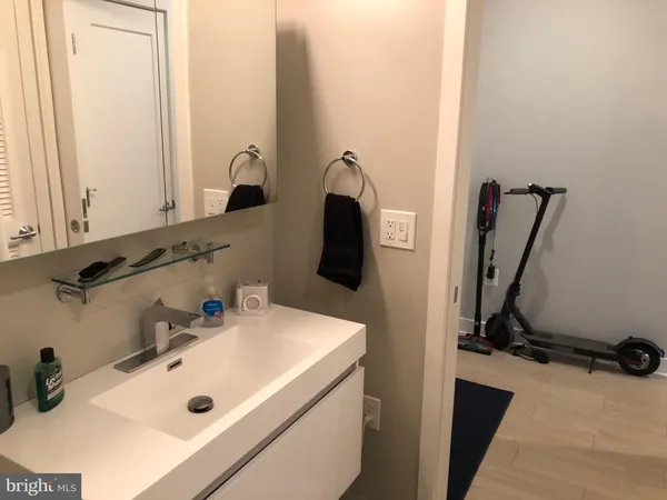 a bathroom with a toilet a sink and mirror
