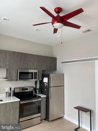 a view of a kitchen with a sink a fireplace and a window