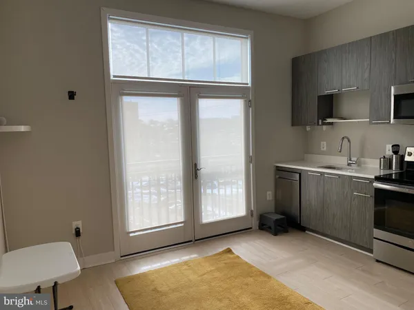 a living room with a walk in closet and a mirror