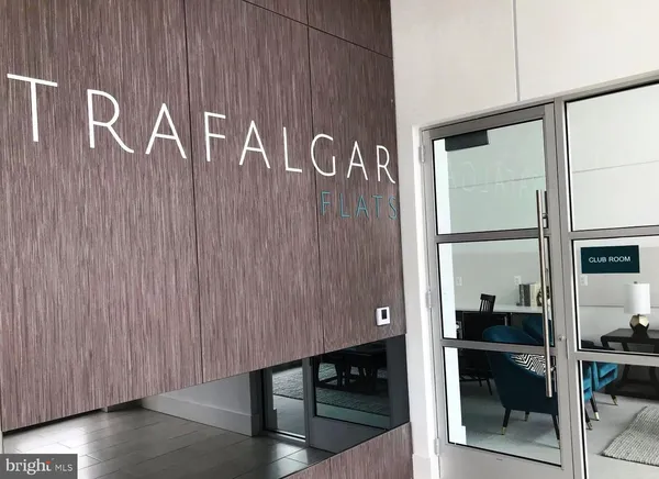 a living room with furniture cabinets and a floor to ceiling window