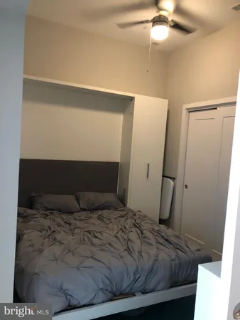 a bedroom with a bed and a flat tv screen