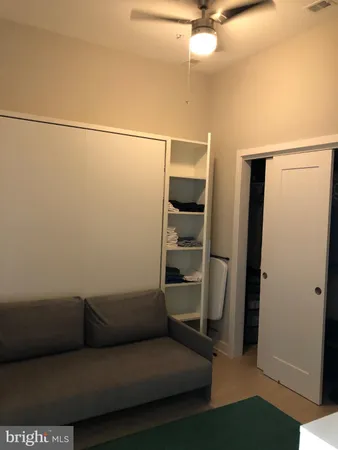 a view of a patio with couches table and chairs and potted plants