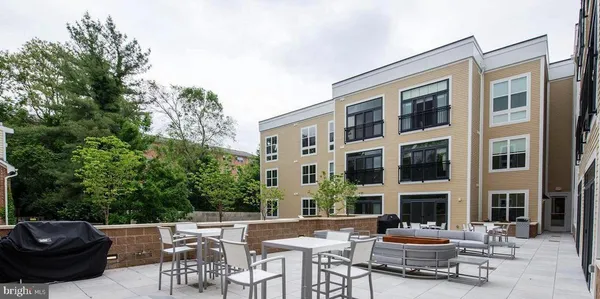 a view of a dinning tables and chairs in a patio