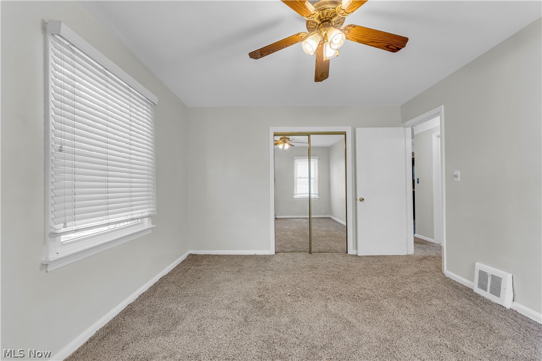 3842 Wallingford Road South Euclid, OH 44121 - Photo 16 of 31 Unfurnished bedroom with a closet, ceiling fan, and carpet floors