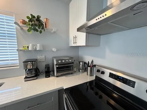 a kitchen with a stove and a cabinets