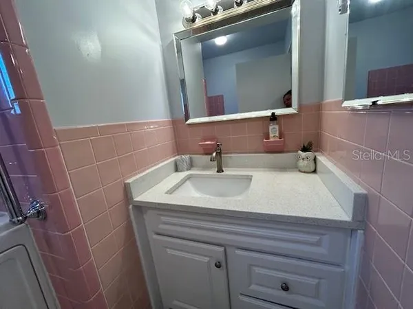 a white toilet sitting next to a bathroom sink and a window