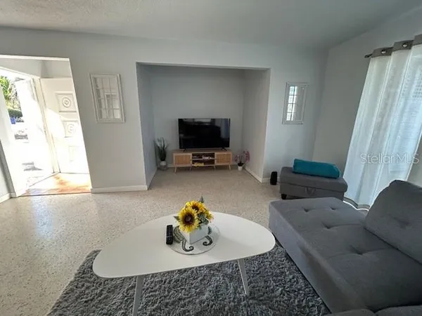 a living room with furniture and a flat screen tv