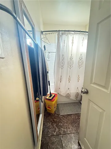 a kitchen with granite countertop a refrigerator and a sink