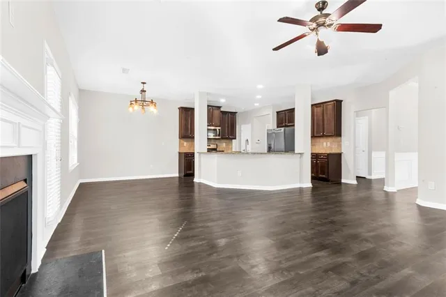 a view of a kitchen with wooden floor and a kitchen