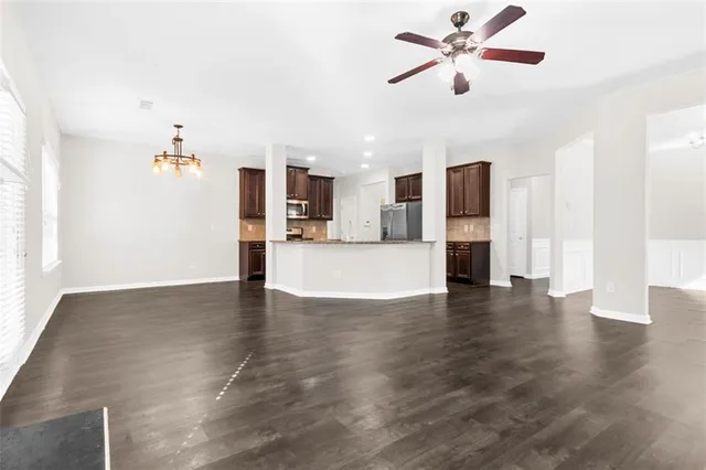 a view of a kitchen with microwave and wooden floor