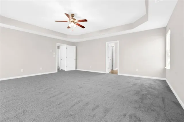 a view of an empty room with a ceiling fan
