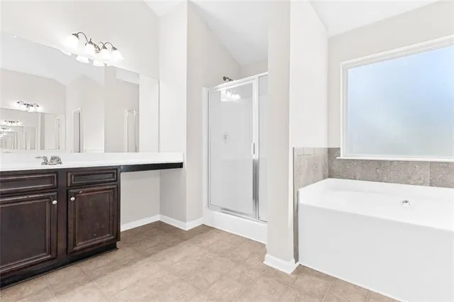 a bathroom with a tub a sink and mirror