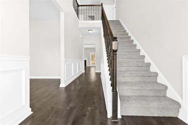 a view of entryway and hall with wooden floor