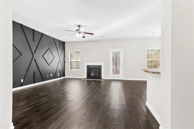 a view of an empty room with a fireplace and a window