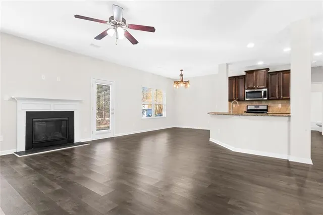 a view of kitchen with microwave stove and cabinets